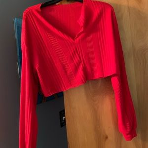 Red long-sleeve v-neck cropped sweater.